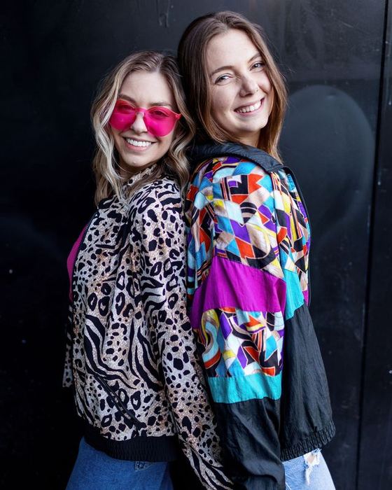 Two friends in a leopard jacket and a bright patterned windbreaker