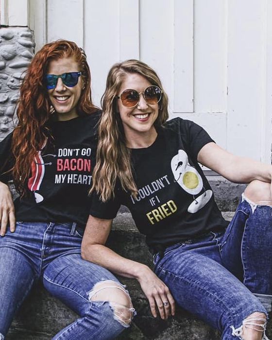 Elissa and Melissa laughing in graphic tees