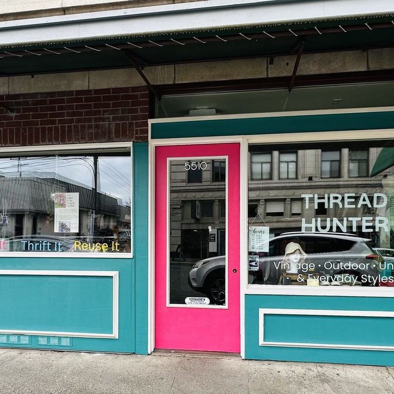 The Thread Hunter storefront from across the street: teal, white trim, the pink door